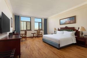 a large hotel room with a bed and a desk at Days Hotel by Wyndham Harbin Qunli in Harbin