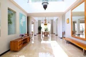 a hallway with benches and tables in a building at Villa Aventus Uluwatu in Uluwatu