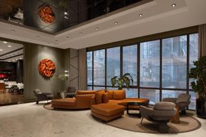 a lobby with a couch and chairs in a building at Delta Hotels by Marriott Istanbul Vadi in Istanbul