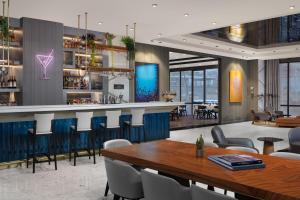 a restaurant with a bar with tables and chairs at Delta Hotels by Marriott Istanbul Vadi in Istanbul