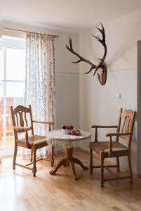 a dining room with a table and two chairs at Haus Kendlinger in Sankt Gilgen