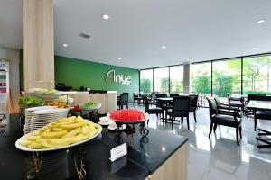 a fast food restaurant with a plate of food on a counter at Anya Nana at Sukhumvit Bangkok in Bangkok