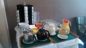 a table with a tray with tea pots and dishes at Tokalis Boutique Hotel & Spa in Nea Anchialos