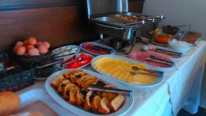 a table with plates of food on a table at Tokalis Boutique Hotel & Spa in Nea Anchialos