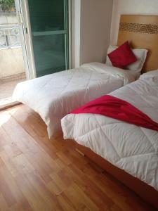 Katil atau katil-katil dalam bilik di Hotel Astoria Tanger