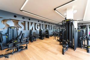 a gym with several treadmills and machines in it at Luxusyacht Mallorca in Portals Nous