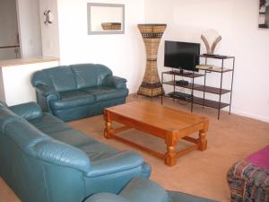 a living room with a couch and a coffee table at Waterside Living NT01 in Jeffreys Bay