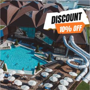 a view of a resort with a pool with umbrellas at Morning coffee w a view :) in Podčetrtek