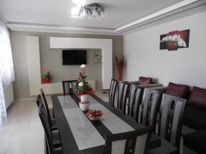 a dining room with a black table and chairs at Szamos-Party Vendégház in Olcsva