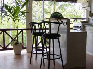 a kitchen with two black bar stools and a counter at The Legend Garden Condos in Saint Peter