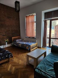 a living room with two beds and a table at City Guli in Tbilisi City