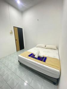 Giường trong phòng chung tại Bukit Kayangan Homestay +2 ảnh