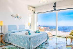 a bedroom with a bed and a view of the ocean at Villa MyHeart in Massa Lubrense