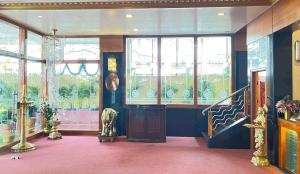 a room with a staircase and windows and a stair case at The Grand Krishna Rooms in Bengaluru