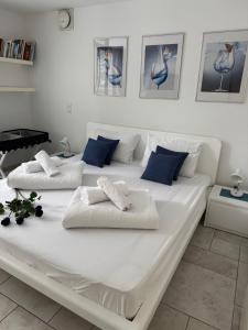 a large white bed with two pillows on it at Anabella Apartment in Izola +24 photos