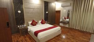 a bedroom with a large bed and a large mirror at Ambassador Suite 1 in Dargai