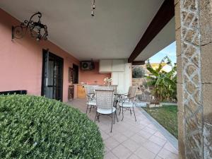 a patio with chairs and a table in a house at Casa di Roberto in Ladispoli
