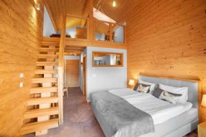 a bedroom with a bed and a wooden wall at Chalet Diognysos B&B, Boutique Hotel & Wellness in Crans-Montana