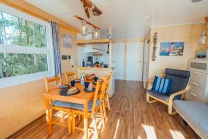 a kitchen and dining room with a table and chairs at Abenteuer Flusslandschaft - Hausboot fest vertäut in Anklam in Anklam +3 photos