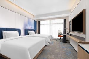 TV a/nebo společenská místnost v ubytování Hampton by Hilton Guangzhou Huangpu Sports Center