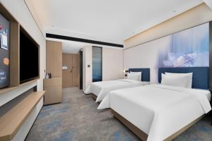 Postel nebo postele na pokoji v ubytování Hampton by Hilton Guangzhou Huangpu Sports Center