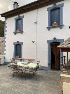 a patio with a table and chairs in front of a building at Maison Boule de Neige, meublé de tourisme 3 étoiles in Formiguères