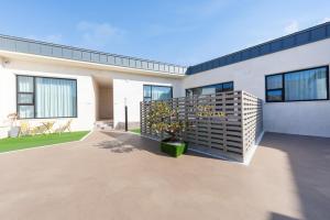 une maison blanche avec une plante en pot devant dans l'établissement Gangneung Ranteuruhe Pension, à Gangneung