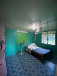 a small room with a bed and a window at Balay y tabs guesthouse in San Vicente +12 photos