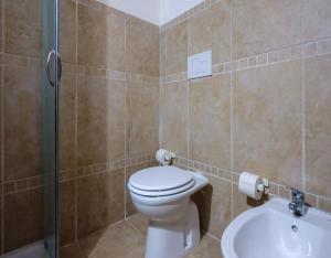 a bathroom with a toilet and a shower and a sink at Belvedere Luxury Seafront With Panoramic Terrace in Porto Cesareo