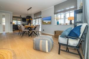 a living room and dining room with a table and chairs at Haus Marit in Westerland