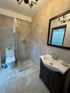 a bathroom with a sink and a shower at Kaleidoscope Boutique Hotel in Craiova +24 photos