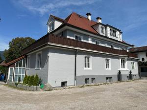 a large white building with a red roof at Haus Alpina in Garmisch-Partenkirchen