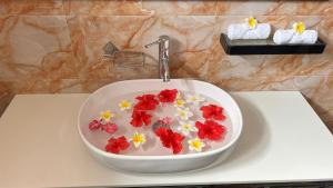 a sink with flowers in it on a counter at skyport villa in Zanzibar City