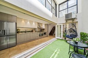 an open kitchen with a table and a large window at Luxe Living Terrace by The Star in Sydney