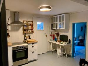 a kitchen with a stove and a table in it at Casa Amador in Alcácer do Sal