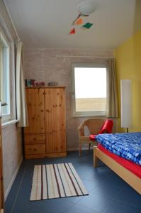 a bedroom with a bed and a window and a dresser at FerienhausLychen in Lychen