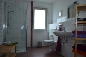 a bathroom with a toilet and a sink and a shower at FerienhausLychen in Lychen +55 photos