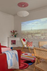 a living room with a bed and a view of a city at Pop-Art квартира Алматы in Almaty