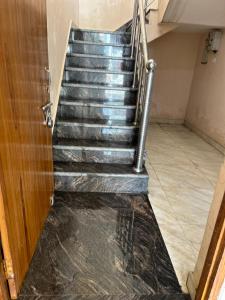 a set of stairs in a room with a door at Home near Holy Mahakumbh in Prayagraj