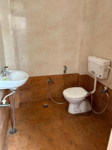 a bathroom with a toilet and a sink at Home near Holy Mahakumbh in Prayagraj