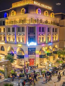 a crowd of people walking in front of a building at Regal Collection Hotels & Suite in Dương Cảnh