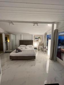 a bedroom with a bed and a living room at Stavento Apartments in Argostoli
