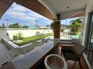 a patio with chairs and a table with a view at 3BR Villa near Boat Avenue Laguna beach in Bang Tao Beach