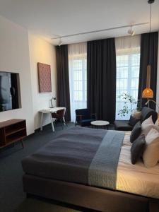 a bedroom with a large bed and a living room at Avatary Miasta in Lublin