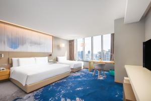 Postel nebo postele na pokoji v ubytování Le Meridien Hangzhou, Binjiang