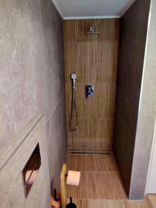 a bathroom with a shower with a wooden floor at Relax Valley in Vărşag +40 photos
