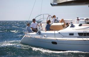 a group of people sitting on a boat in the water at Madyson Sailing in La Spezia