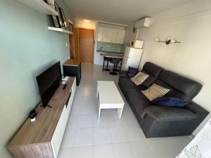 a living room with a couch and a table at LV Aquario I in La Pineda