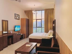 TV a/nebo společenská místnost v ubytování New Dream Plaza Hotel Apartment