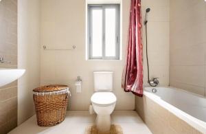 a bathroom with a toilet and a tub and a sink at Elegant central apartment in Sliema +15 photos